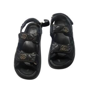 Authentic Chanel black leather sandals with CC logo hardware.